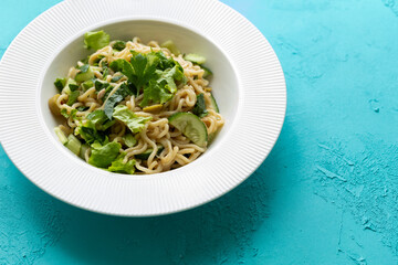 Asian noodle salad in white plate in close-up