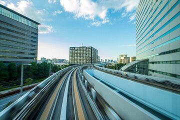 View of a modern city skyline from the head of a train in long exposition