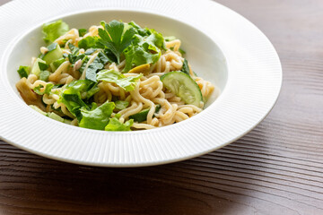Asian noodle salad in white plate in close-up