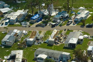 Severely damaged houses after hurricane Ian in Florida mobile home residential area. Consequences...