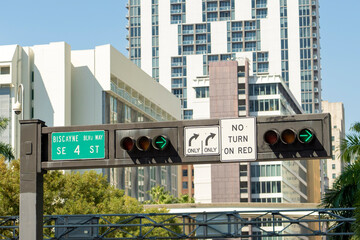 Traffic lights regulating driving cars on city street in Miami, Florida