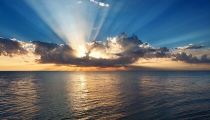 majestic sun rays breaking through dark clouds over the ocean at dusk