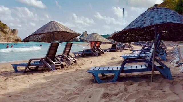 Empty Sunbeds and Straw Umbrellas on a Sandy Beach Resort