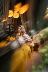 beautiful girl with lemons in a cafe on a summer day
