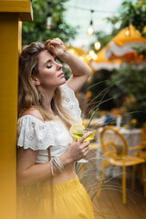 beautiful girl with lemons in a cafe on a summer day
