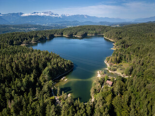 Forstsee in Carinthia, Austria, Surrounded by Dense Forest and Majestic Mountains