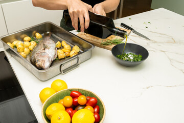 Delicious Snapper Fish and Potatoes Preparation with Fresh Ingredients in a Modern Kitchen Setting