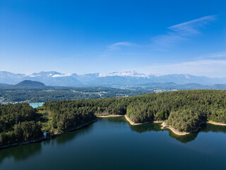 Forstsee in Carinthia, Austria, Surrounded by Dense Forest and Majestic Mountains
