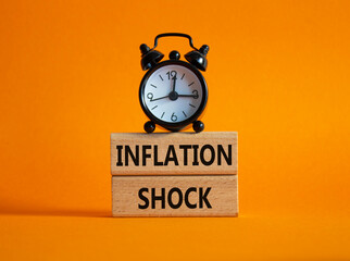 Inflation Shock symbol. Concept word Inflation Shock on wooden blocks. Beautiful orange background...
