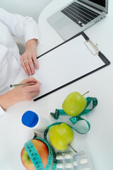female doctor consulting with overweight patient, discussing test result in doctor office. Showing...