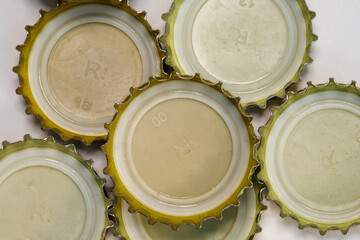 Several Used Bottle Caps on a White Background