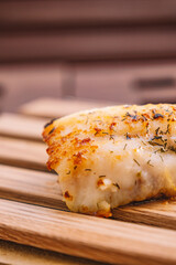 Close-up of a piece of fish cooked with spices. Healthy living concept.