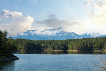 Forstsee in Carinthia, Austria, Surrounded by Dense Forest and Majestic Mountains