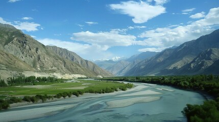Scenic view of the Indus River, a historic waterway flowing through Pakistan and India, featuring calm waters, fertile riverbanks, traditional boats, rural villages, and lush vegetation