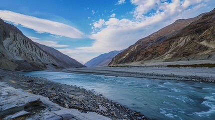 Scenic view of the Indus River, a historic waterway flowing through Pakistan and India, featuring calm waters, fertile riverbanks, traditional boats, rural villages, and lush vegetation