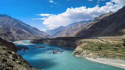 Scenic view of the Indus River, a historic waterway flowing through Pakistan and India, featuring calm waters, fertile riverbanks, traditional boats, rural villages, and lush vegetation