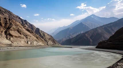 Scenic view of the Indus River, a historic waterway flowing through Pakistan and India, featuring calm waters, fertile riverbanks, traditional boats, rural villages, and lush vegetation