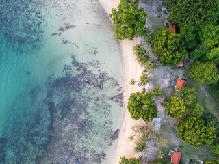 Aerial View of Tropical Beach with Kayak and Bungalows in Shallow Waters