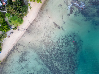 Aerial View of Tropical Shoreline with Kayak in Turquoise Water