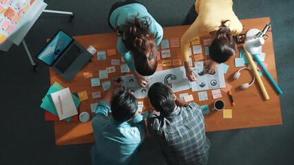 Top view of business team write graphic logo on meeting table with colorful sticky notes and design while explain idea. Project manager sharing idea and explain concept art to smart team. Symposium. - Powered by Adobe