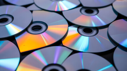 CDs Dispersion: A collection of CDs scattered, showing their reflective surfaces with vivid and varied colors. Capturing the simple geometric beauty and nostalgic charm of the compact disc era.