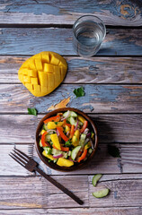 Cucumber red onion mango red bell pepper salad in a bowl