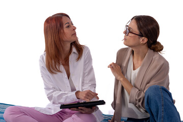 Two women discussing work on tablet, networking and distance working