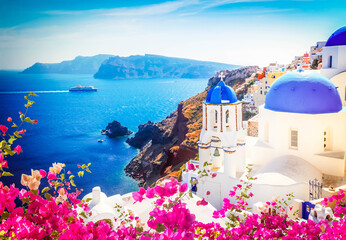 volcano caldera with blue church domes, Oia with flowers, Santorini, toned © neirfy