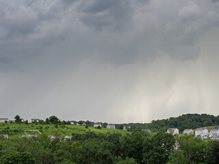 Incoming storm over Pennsylvania's green hills and scattered homes