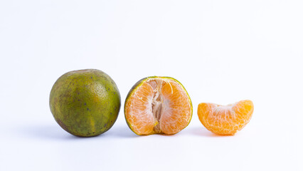Progression of an orange from whole, half-peeled, and a single slice on isolated white background...
