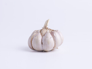 A head of garlic with a detailed skin texture on a white background. Concepts for food, spice, condiment, ingredient, cooking, healthy, organic, isolated, vegetarian.

