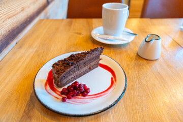 Milk and coffee with Norwegian style dark chocolate cake, thick cocoa shavings and creamy, rich...