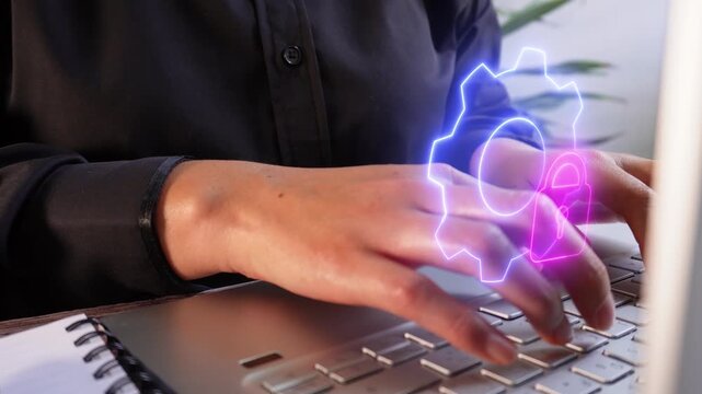 Close-up of a businesswoman working on her computer with a floating icon of a gear and a lock.