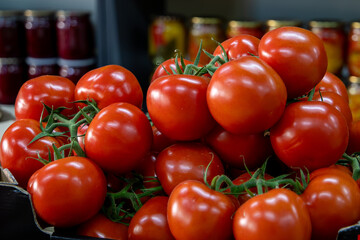 Many ripe red tomatoes. Cherry tomatoes. Pink tomatoes. Tomatoes in a box. Sale of tomatoes at the...