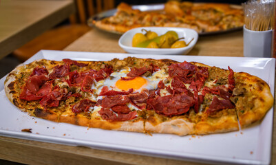 A hot Turkish pide with pastirma cured beef and an egg at in Istanbul, Turkey