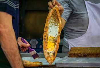 Chef showing a Turkish pide with meat, fresh out of the oven, Istanbul, Turkey