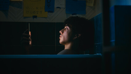 Tired And Stressed Man Lost In The Light Of The Smartphone