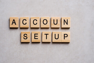 Account setup spelled with wooden letter tiles on beige background, business startup concept, user registration process, online account creation, digital onboarding, workspace flatlay, modern technolo