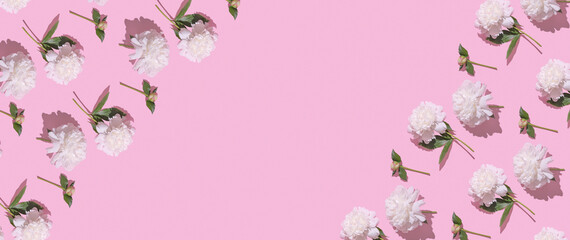 Delicate white flowers arranged artistically on a vibrant pink background for a cheerful decoration