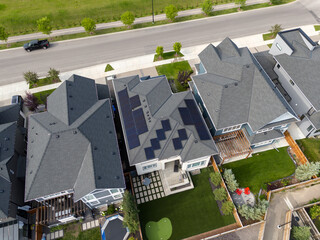 Looking down on new suburban homes with solar panels installed on the roof.