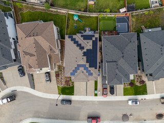 Looking down on new suburban homes with solar panels installed on the roof.