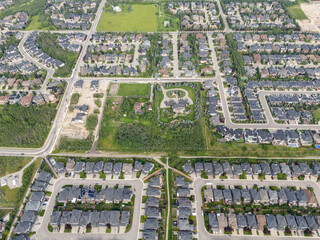 View of homes during the summer in Aspen Estates area of Calgary, Alberta.