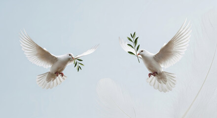 Fototapeta premium Two white doves in flight carrying olive branches against a light blue and white gradient background