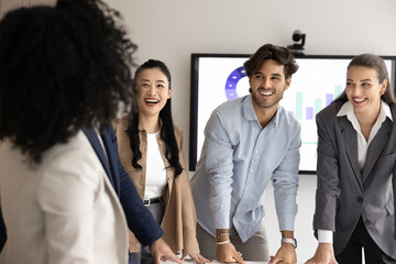 Joyful brainstorming. Friendly diverse young businesspeople coworkers of different ethnicities...