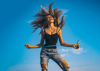 Slim sport woman is showing waist. Fit fitness sport girl measuring her waistline with jump rope. Sport slim woman measuring her waist. Slim body. Girl with perfect slim waist. Excited sport.