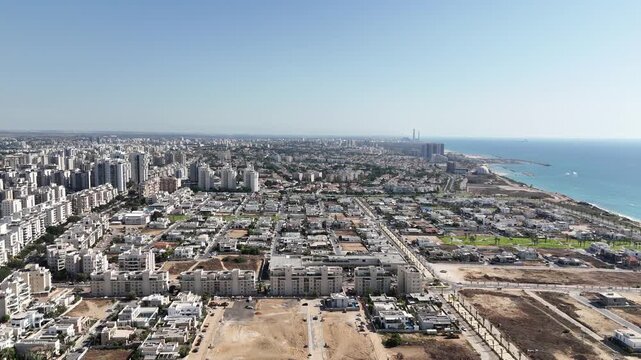 Aerial drone view of waves crashing against the breakwater in Ashkelon, Israel. Powerful sea motion and coastal scenery captured from above.

