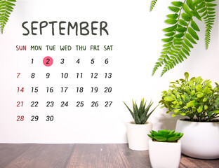 Wooden calendar with the date September 2. Monthly calendar