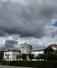 Old and new building in Prague city with cloudy sky. Square in stormy weather, capital of Czech Republic, one of the most beautiful cities Prague, Europe.