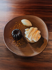 Luxury plated dessert with chocolate pastry, creamy filling, and ice cream