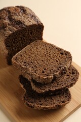 Pieces of fresh rye bread on beige background, closeup